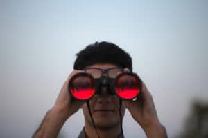 Man using hunting binoculars