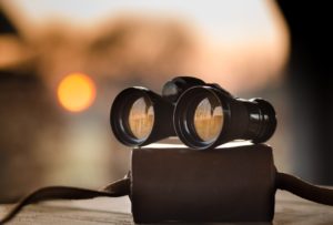 Binoculars placed on top of an unidentified object
